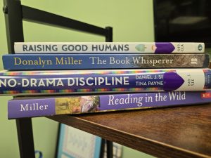 An image showing a few of my favorite parenting and reading-related books: Raising Good Humans, The Book Whisper, No-Drama Discipline, and Reading in the Wild